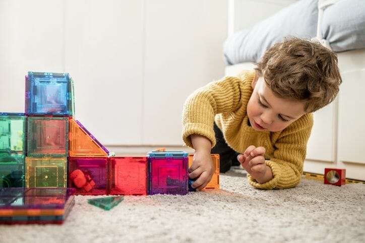Youth child playing with toys as an image within a post about the Social Building Blocks program from the YMCA South Hampton Roads