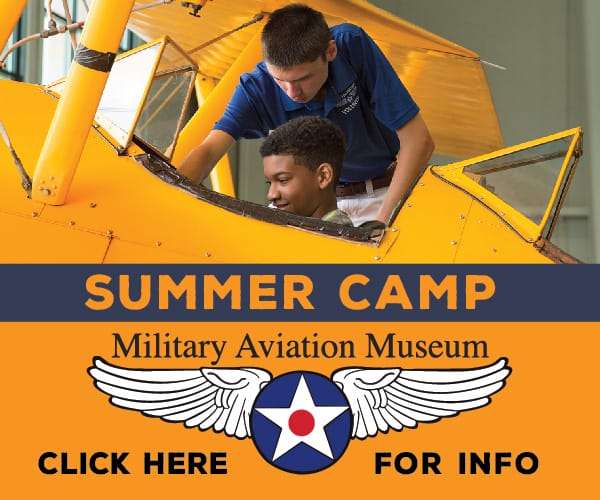 Child sitting in the cockpit of an antique plane as an instructor explains the controls - illustration of Summer Camp at Military Aviation Museum Virginia Beach with a call to action to click here for information.